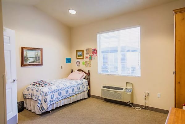 Cozy interior of a private resident room with bed and decor