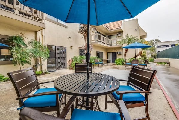 Outdoor seating area with umbrellas and plants