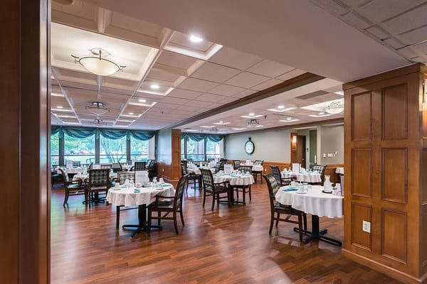 Dining area with neatly set tables and wooden decor
