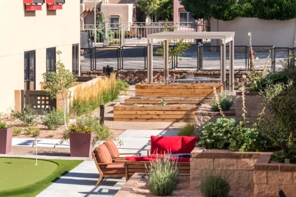 Outdoor garden area with seating and plant beds