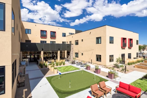 Outdoor space with seating and putting green