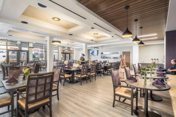 Bright dining room with residents enjoying meals