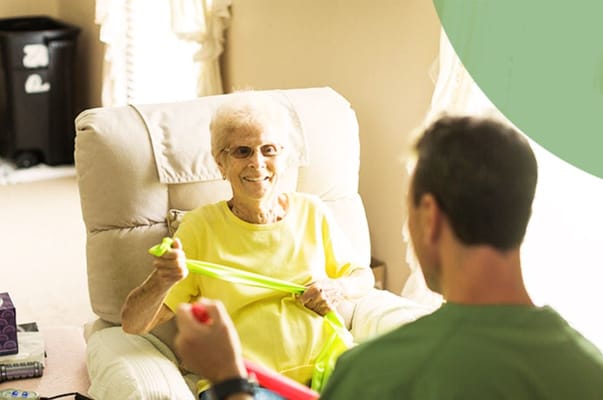 Senior resident engaging in therapy with a staff member