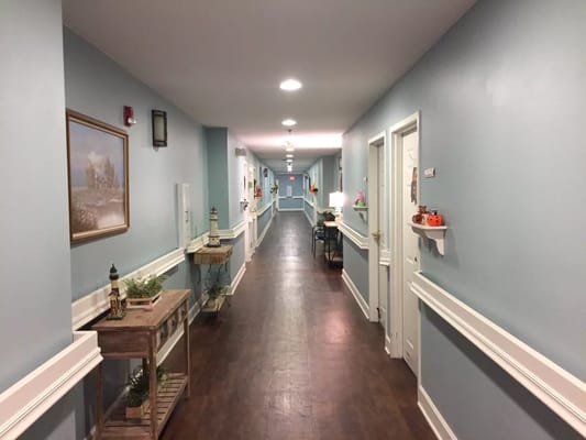 Interior hallway with soft blue walls and decorations