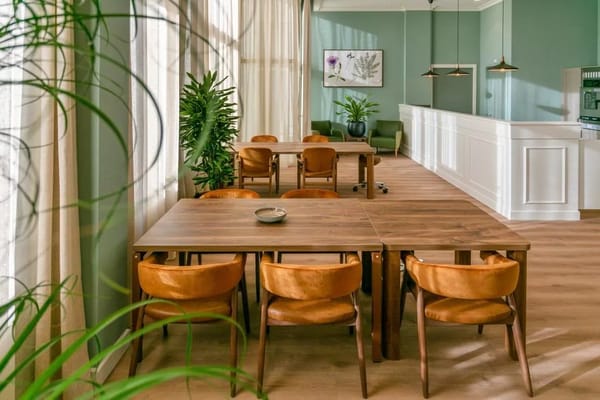 Bright interior of a common area with wooden tables and chairs