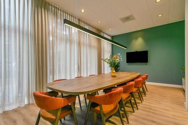 Interior dining area with a large table and modern decor
