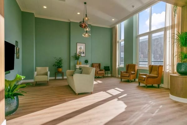 Bright common area with comfortable seating and large windows