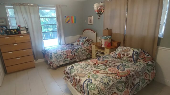 Cozy shared bedroom with two beds and natural light