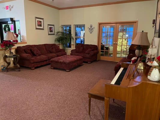 Cozy common area with seating and a piano