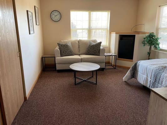 Cozy interior room with seating area and bed