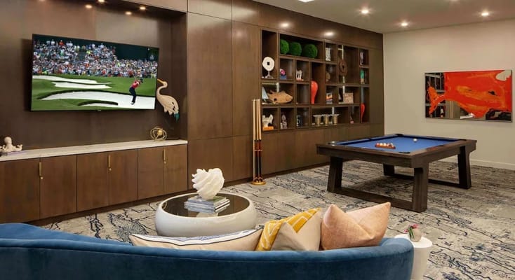 A cozy common area featuring a pool table and TV