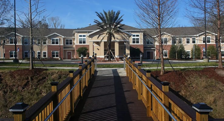 Exterior view of Anthem Lakes facility with wooden bridge