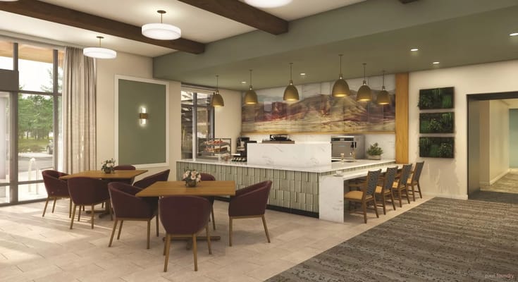 Bright common area with dining tables and modern decor