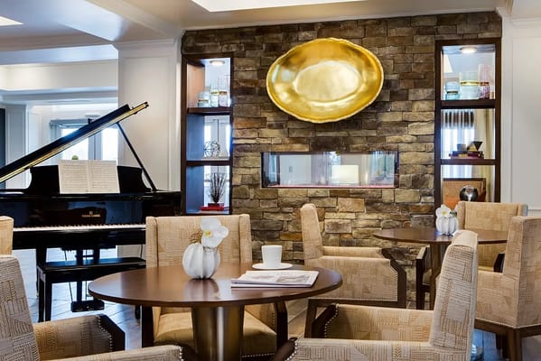 Cozy lounge area featuring a grand piano and elegant seating.