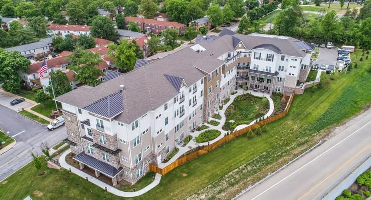 Aerial view of a senior living facility with landscaped grounds