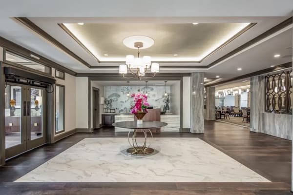 Bright and spacious lobby with floral arrangement and modern decor.