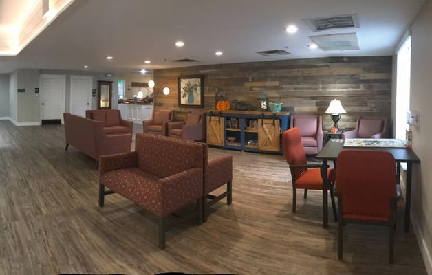 Common area with seating and decor in a senior living facility