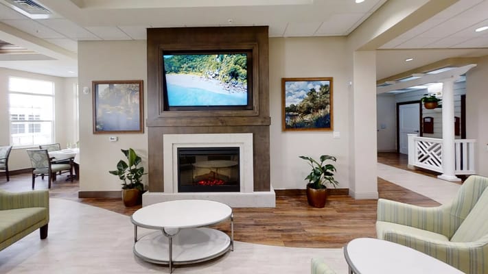 Cozy interior lounge area with a fireplace and artwork