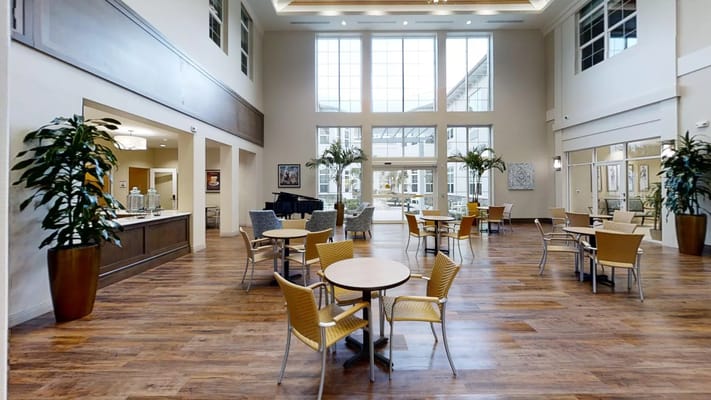 Bright common area with seating and piano