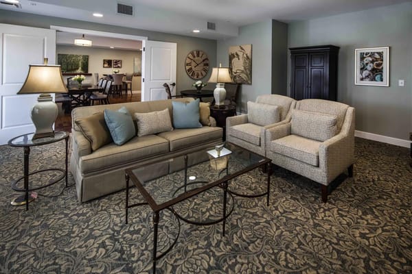 Common area with seating and decor in a senior living facility