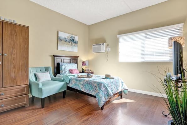 Cozy resident room with a bed and chair