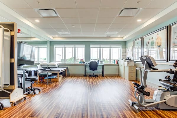 Interior view of a physical therapy room with exercise equipment
