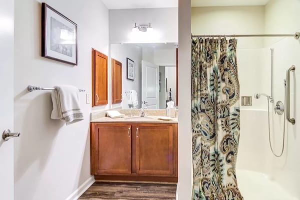 Modern bathroom with decorative shower curtain and amenities