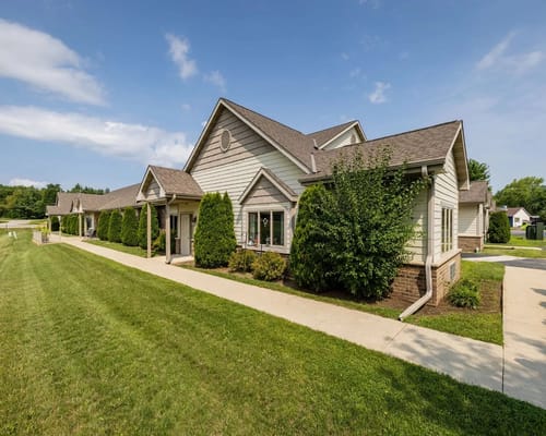 Exterior view of an assisted living facility with landscaped lawn