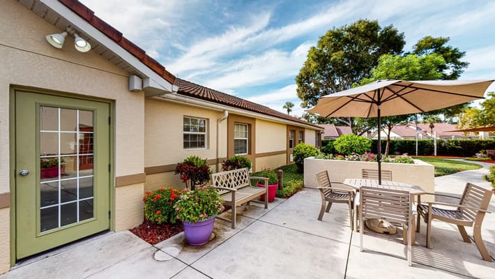 Outdoor patio area with seating and landscaping