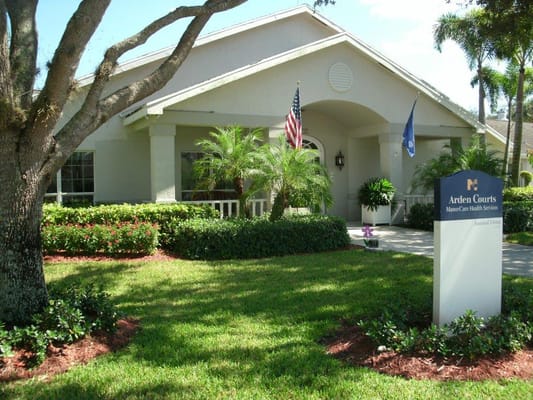 Exterior view of a senior living facility with landscaping