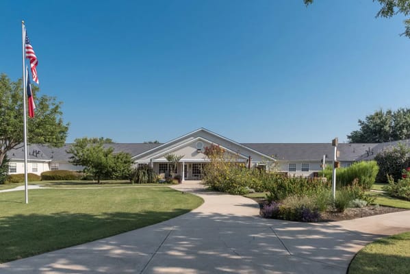 Exterior view of Arden Courts of Richardson with landscaped grounds