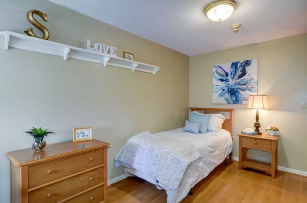 A cozy resident room with a bed and decor