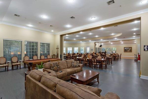 Bright, spacious common area with dining tables