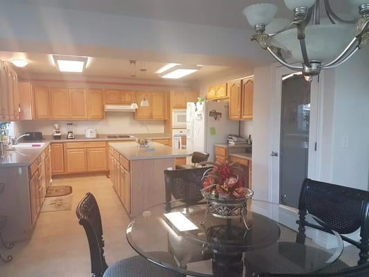 Bright kitchen area with wooden cabinets and dining table