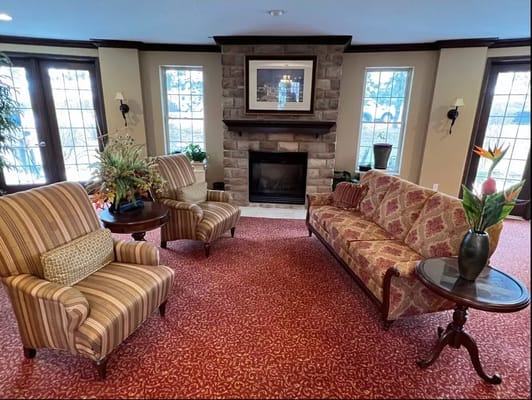 Cozy common area with seating by a fireplace