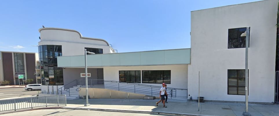 Exterior view of Arosa Los Angeles facility with a pedestrian