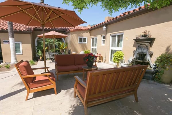 Outdoor seating area with comfortable furniture and umbrella