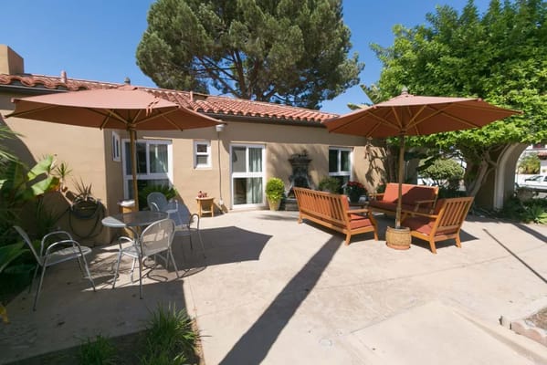 Outdoor seating area with umbrellas and greenery