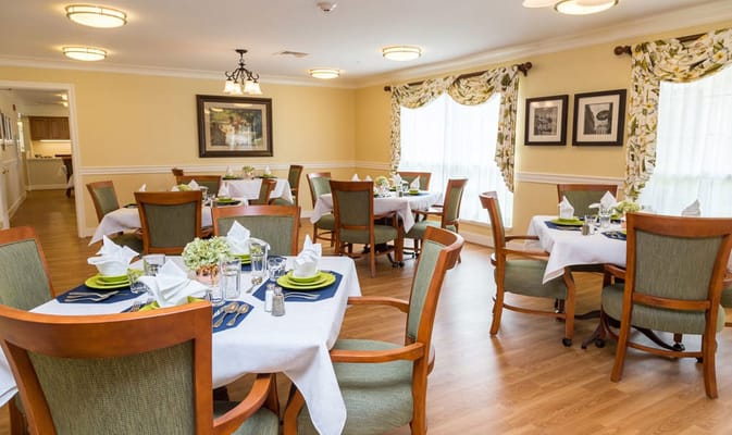 Dining room set up for residents with table settings