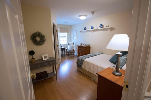 Cozy resident room with a bed and sitting area