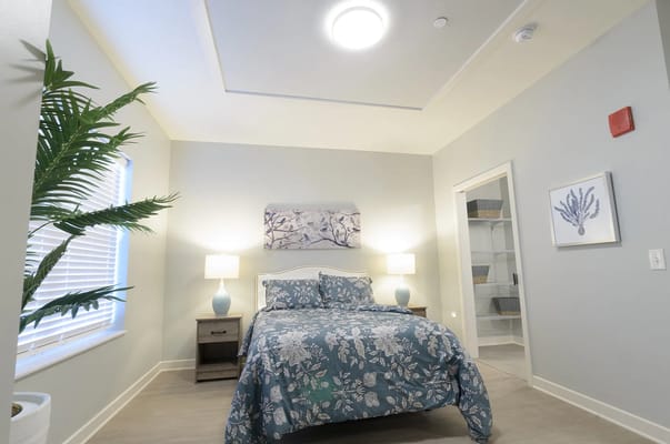 Brightly decorated resident room with a bed and decor