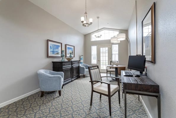 Bright common area with seating and a computer station