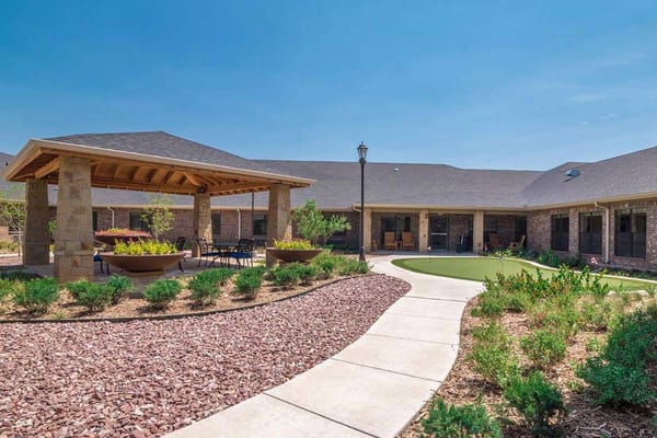 Outdoor space with landscaped pathways and seating areas