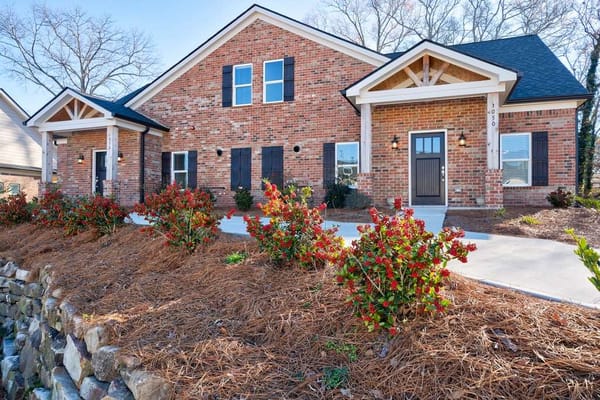Exterior view of a nursing home facility with colorful landscaping