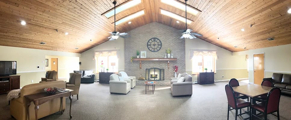 Bright common area with comfortable seating and a fireplace