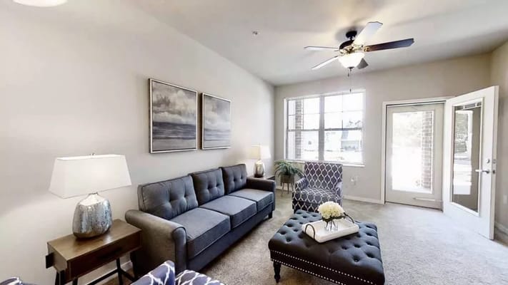 Spacious living room with a sofa, armchair, and coffee table