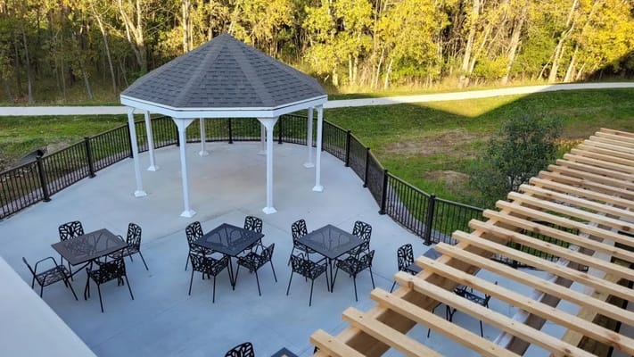 View of outdoor gazebo with seating at Aspire Senior Living Oshkosh