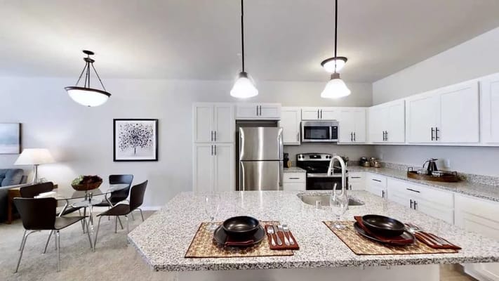 Spacious kitchen with stainless steel appliances and dining area