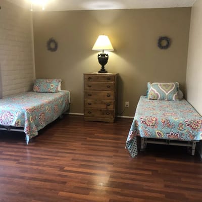 Cozy private room with two beds and a lamp