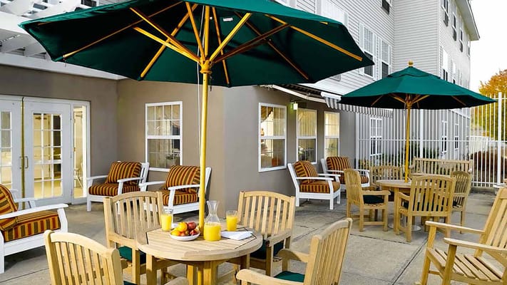 Outdoor seating area with tables and umbrellas